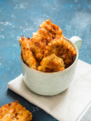 Homemade fried chicken cutlets, fillet nuggets in ceramic mug on blue background. Diet concept. Healthy food
