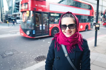 Fotobehang The beautiful tourist girl in London with a red bus in the background. © petrustan