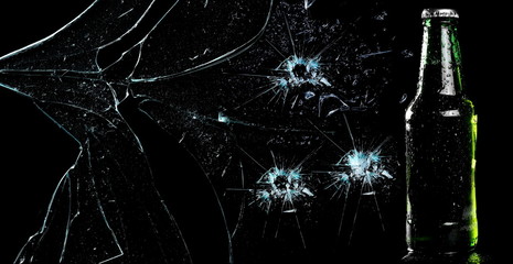 Beer bottle with drops with bullet effect, broken glass texture isolated on black, clipping path 