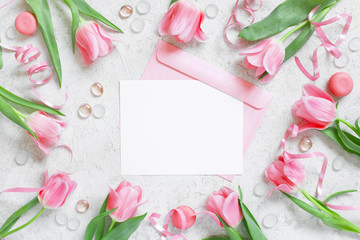 Blank white postcard with envelope and frame of tulips