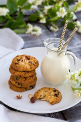 Chocolate chip cookies with milk on  wooden table
