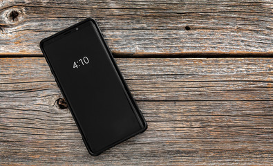 Smartphone on a wooden background.