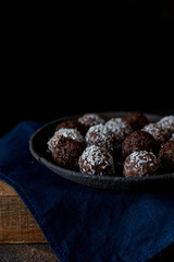 Chocolates on the plate with blue towel dark photo