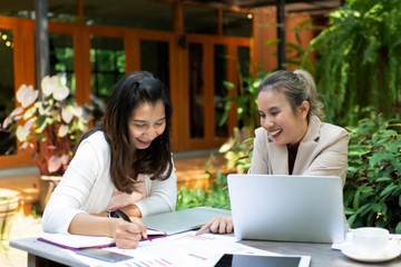 Happy two business woman working