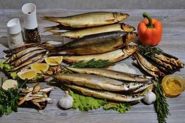 smoked fish mackerel or scomber on a white parchment paper, close-up, top view
