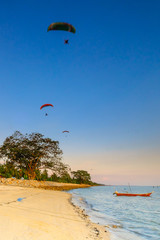 A scenery of sunset with  paragliding  at Bukit Batu beach, Senggarang, Malaysia. Soft focus during long exposure shot.