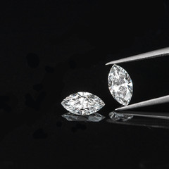 marquise diamond with tweezer on black background