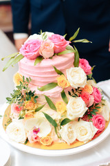 Obraz na płótnie Canvas beautiful huge wedding cake with flowers and fruits