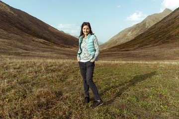  flirty young woman on a sunny day in the mountains