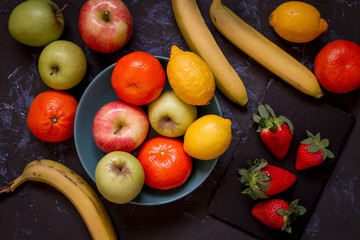 Obraz na płótnie Canvas Varied fruits with dark background