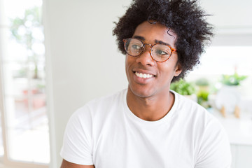 African American man wearing glasses smiling looking side and staring away thinking.