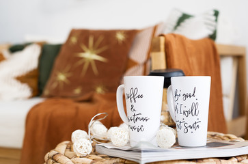 Two white cups for coffee on christmas background.