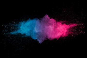 Explosion of multicolored dust on black background.