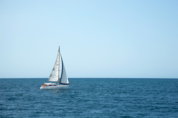 Sailboat sailing on the sea. Ship sailing in full sails on the sea. Yacht in the sea.