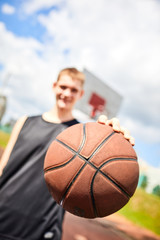 male playing basketball outdoor