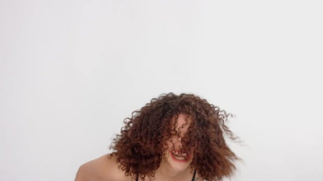 mixed race model with freckles have fun shaking her head and laughing