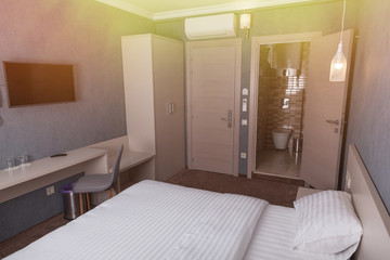 Interior of a cozy hotel room, bedroom.