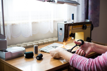 pattern  scissors  tape measure  and a sewing machine. Dressmaker cuts dress