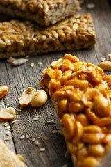 Casinak made from peanuts, on old vintage background, with burlap cloth. Country style. Delicious sweets from seeds of sunflower, sesame and peanuts, covered with shiny glaze