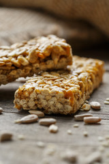 Casinac from sunflower seeds on old vintage background with burlap cloth. Country style. Delicious sweets from seeds of sunflower, sesame and peanuts, covered with shiny glaze