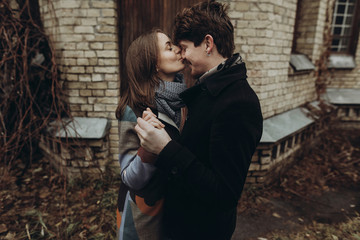 stylish man and woman kissing.romantic calm atmospheric moment. couple hugging gently in autumn park, showing true feelings. family togetherness concept