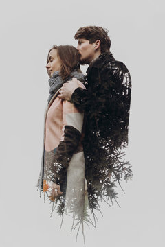 double exposure with romantic couple and tree branches in autumn park. sensual  calm atmospheric moment of stylish hipsters with space for text. man kissing head woman . creative unusual photo