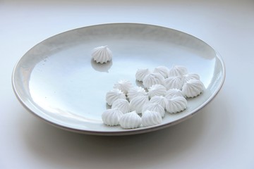Meringue lie on a large bright plate