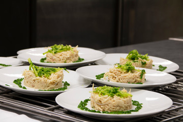 fish dish with spinach on a white plate