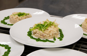 fish dish with spinach on a white plate