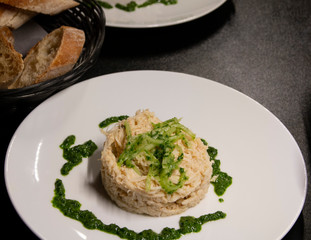 fish dish with spinach on a white plate