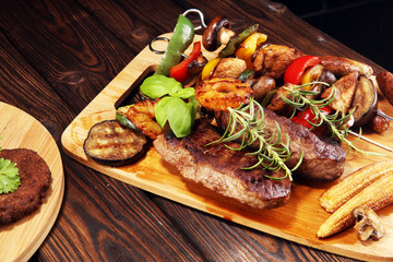 Assorted delicious grilled meat with vegetable on rustic table