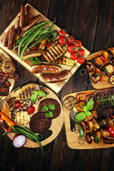 Assorted delicious grilled meat with vegetable on rustic table