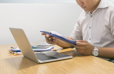 Close-up of businessman hands holding document and reading