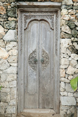 Balinese wood carved doors with traditional local ornaments.