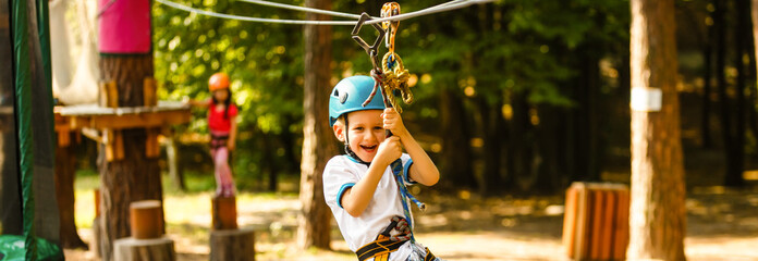 Five year boy on rope-way in forest