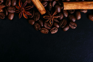 Cinnamon sticks, star anise, coffee beans on the kitchen table. Fragrant spices for coffee drink,...