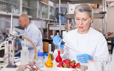 Woman biochemist checking fruits and vegetables