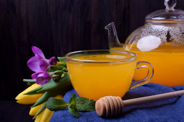 Orange sbiten in a glass cup. Traditional Russian drink with honey