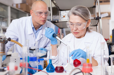 Chemists mixing reagents