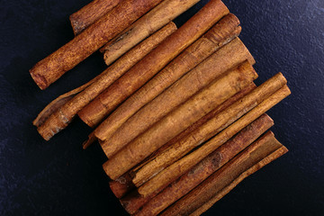 Cinnamon sticks on the kitchen table. Fragrant spices, closeup.