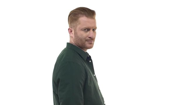 Slowmotion good-looking confident redhead bearded man standing back turning camera nodding yes approval, smiling pleased, liking plan, agreeing participate, giving positive reply, white background