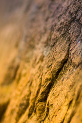 Granite rocks in orange toning. Granite close up. Texture of the stone with yellow color. Background from natural material with warm colors