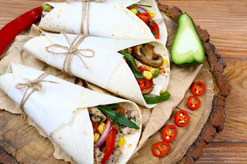 wrapped tortilla stuffed with beef chili and cilantro. Mexican food concept