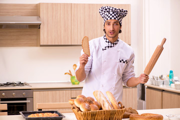 Young male baker working in kitchen 