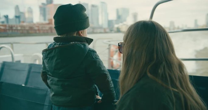 Mother and toddler on a river cruise in the city