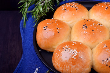 Golden round buns for burgers topped with sesame seeds