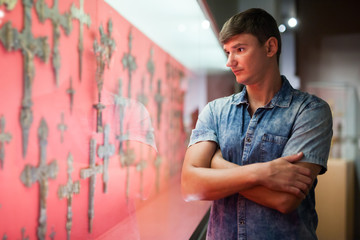 Man looking at stands with exhibits