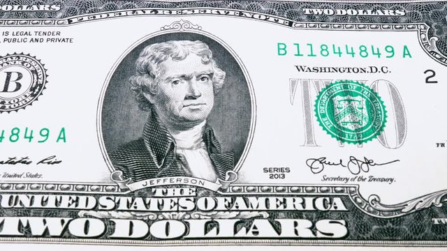 Sliding video of a two US dollar bill note, showing the portrait of US President Thomas Jefferson. Macro shot. Close up.