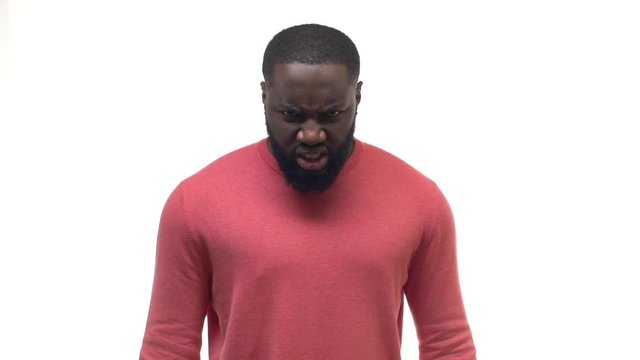 Slow motion african american angry man looking under forehead contempt, disdain, wrinkling nose scorn, mad, staring aggressively, pissed off, yelling anger, raising hands squeeze fists hateful