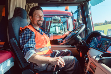 LKW-Fahrer oder Fernfahrer sitzt in der Fahrerkabine des Fahrzeugs